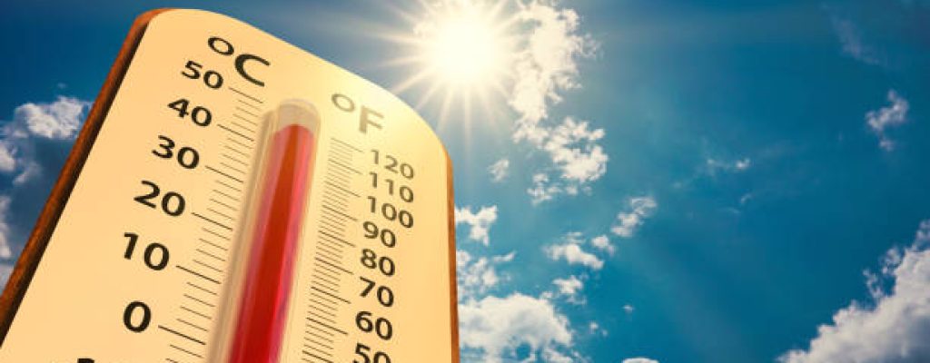 climate change, low angle view Thermometer on blue sky with sun shining in summer show increase temperature, concept global warming